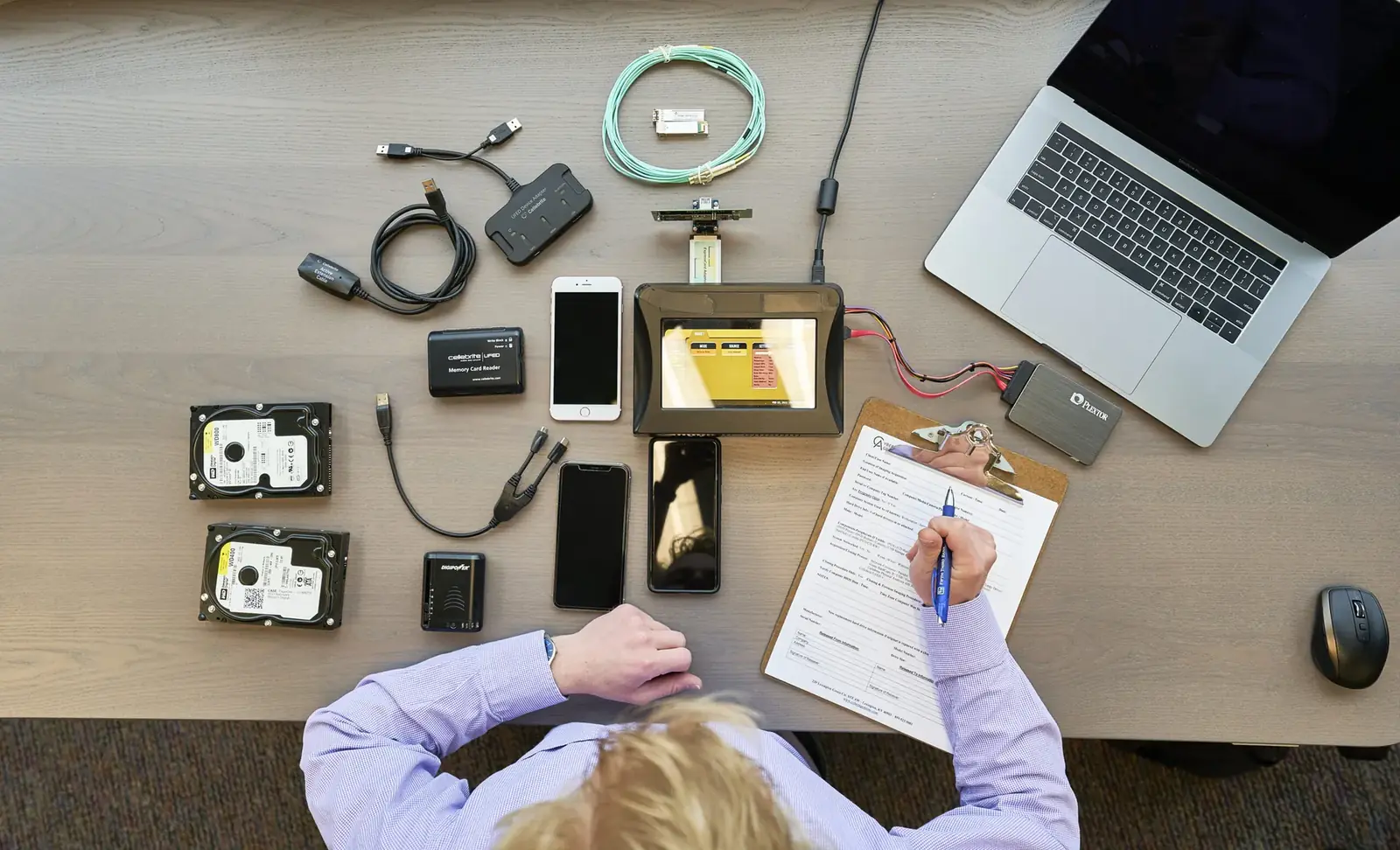 Close view of a forensic examiner extracting data from a mobile device.