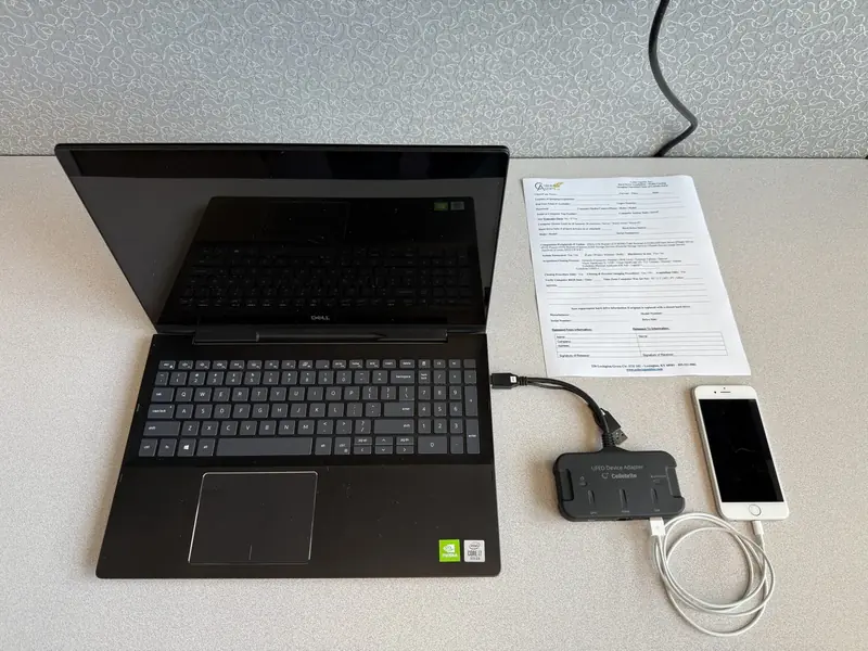 A mobile device connected to a forensic extraction workstation.